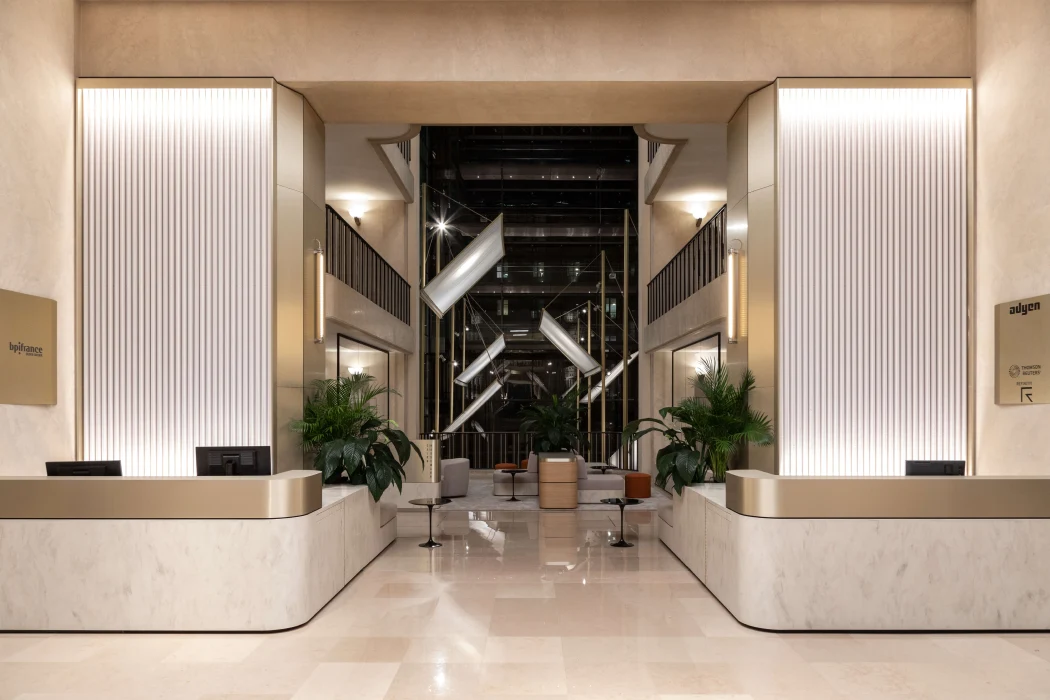 The lobby of a modern building with a marble floor.